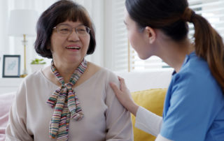 Young asian woman or nurse home care hand on senior grandmother