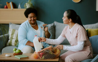 HMC Home Care caregiver assisting senior at home with groceries, representing consistent caregiving and personalized in-home support