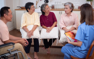 Family discussing home care options around table with paperwork, emotional first conversation about senior care planning and aging in place, HMC Home Care